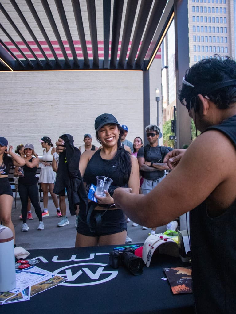 Woman holding up a black shirt smiling