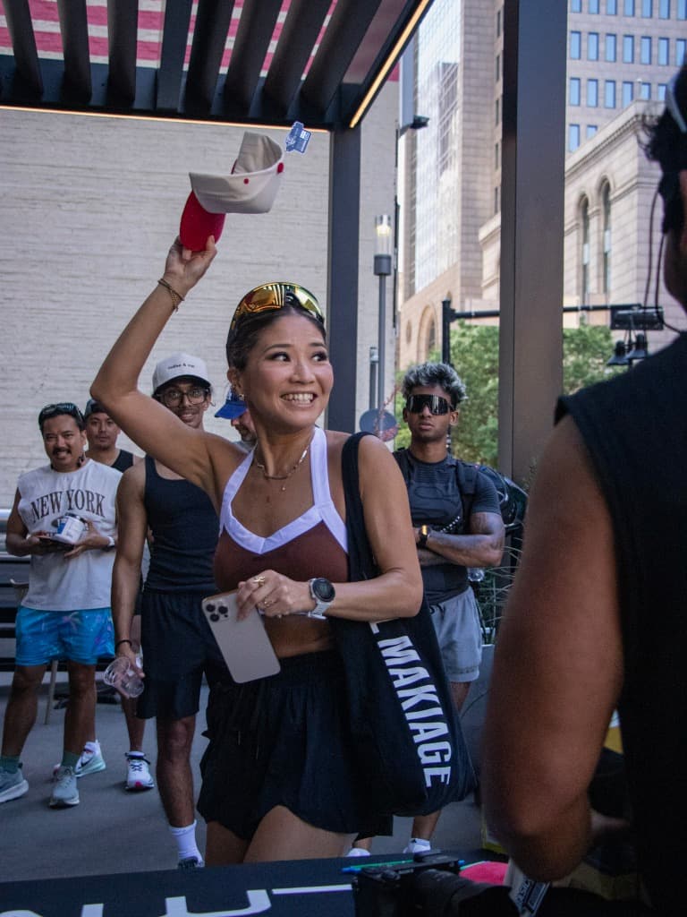 Woman holding up a hat smiling