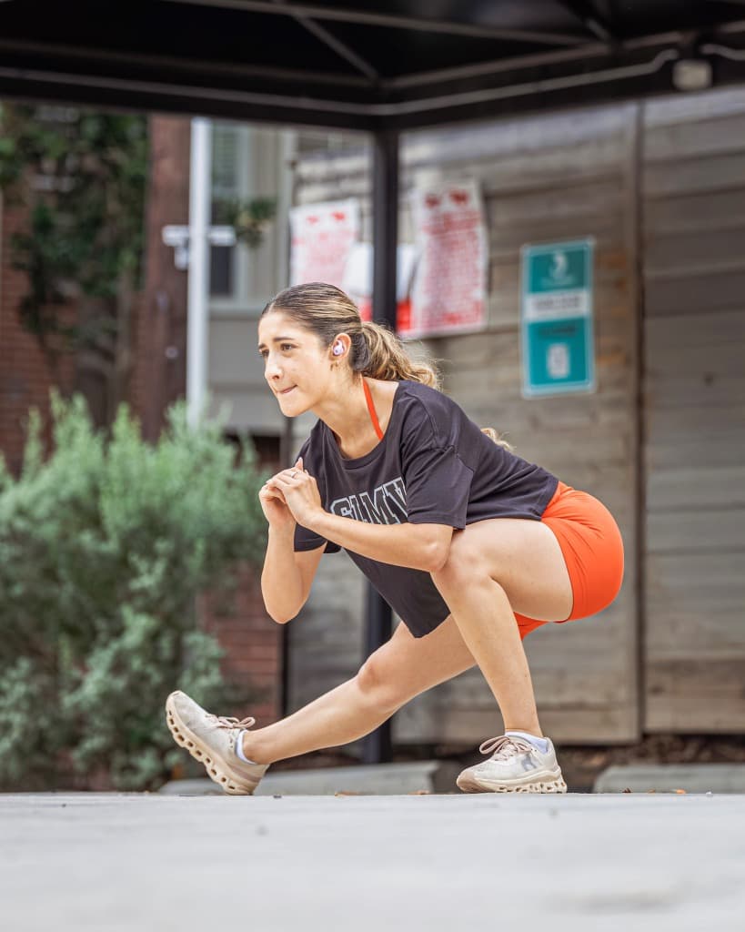 Woman stretching in orange shorts